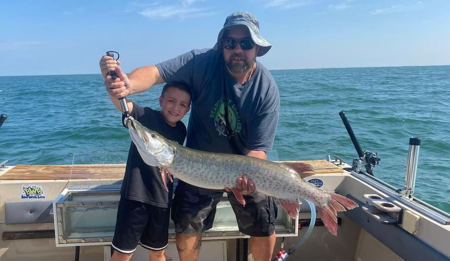 Reaper Musky Charters Boy holding big musky caught with Reaper Musky Charters